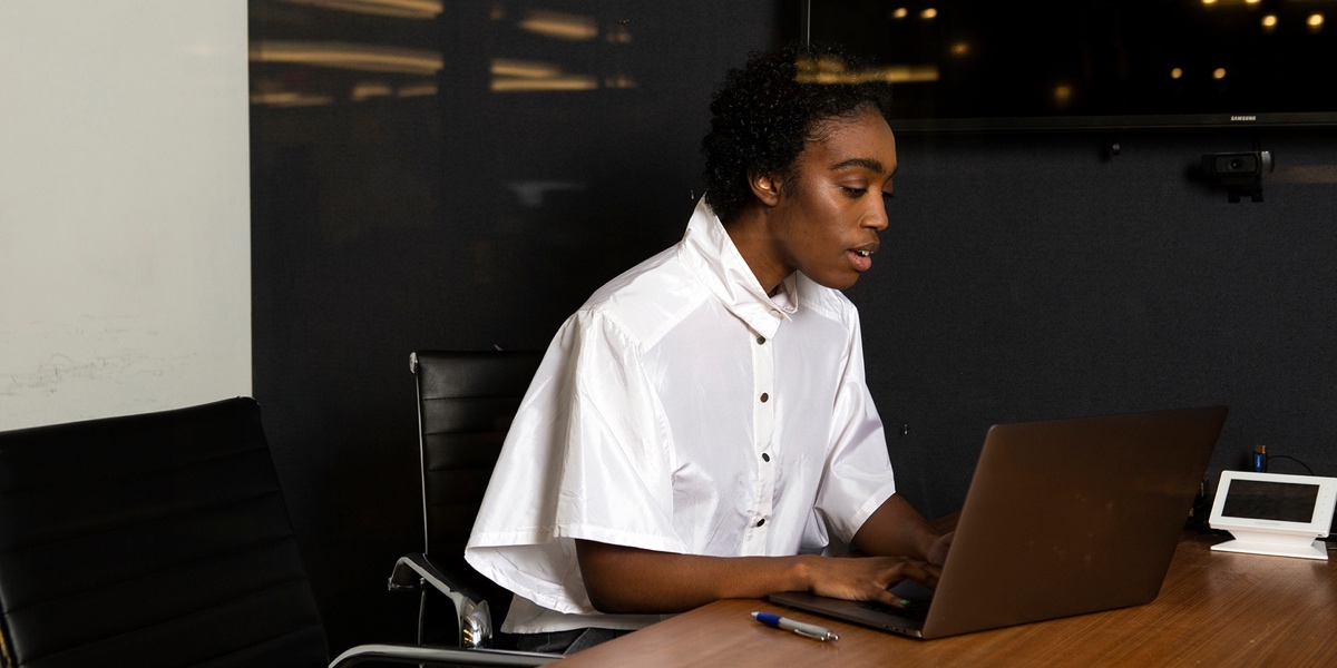 A UX designer sitting at their desk, working at a laptop